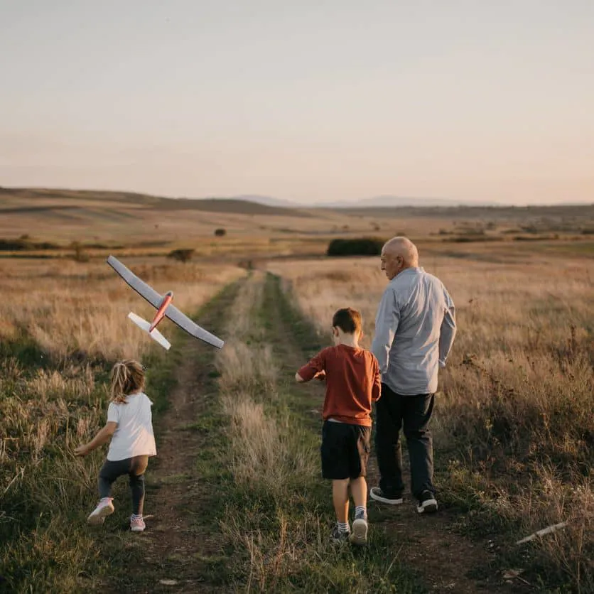 Grandad and kids flying a plane.