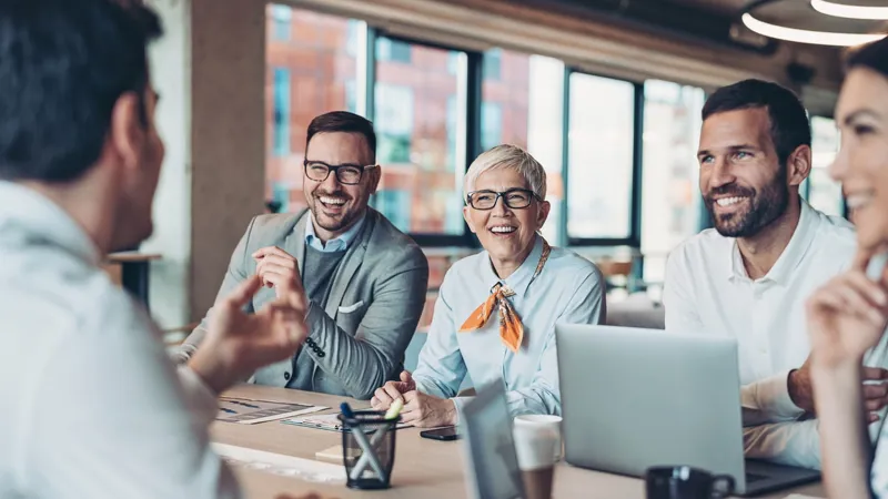 Coworkers smiling during a meeting.