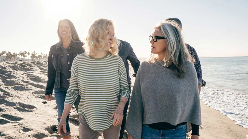 Group of women walking on the beach.